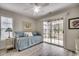 A versatile spare bedroom showcasing a daybed, neutral paint, and sliding door access to the backyard at 1411 Powhaton Dr., Myrtle Beach, SC 29577