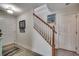 Welcoming entryway with staircase, tiled floor, and white painted doors at 1411 Powhaton Dr., Myrtle Beach, SC 29577