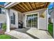 Covered patio with grill, sliding glass doors and outdoor decor with white siding at 1411 Powhaton Dr., Myrtle Beach, SC 29577