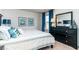 Comfortable bedroom with a striped bedding set, matching nightstand and artwork, and a mirror at 1450 Nokota Dr., Conway, SC 29526