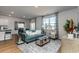 Bright living room with a comfortable sofa, stylish decor, and scenic lake views at 1450 Nokota Dr., Conway, SC 29526