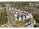 An aerial view of a traditional style home nestled in a quaint neighborhood with sidewalks and lush landscaping at 159 Terracina Circle, Myrtle Beach, SC 29588