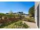 Backyard featuring a small patio and lush greenery, and a view of neighboring homes at 159 Terracina Circle, Myrtle Beach, SC 29588