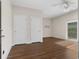 Spacious bedroom features wood-look flooring, neutral walls, ceiling fan, and sliding glass door leading to the exterior at 159 Terracina Circle, Myrtle Beach, SC 29588
