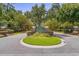 A beautiful entrance to a gated community with lush landscaping and mature trees at 159 Terracina Circle, Myrtle Beach, SC 29588