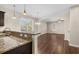 Modern kitchen featuring granite countertops, stainless steel sink, pendant lighting, and a view of the living area at 159 Terracina Circle, Myrtle Beach, SC 29588