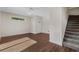 Bright living room boasts hardwood floors, neutral walls, a staircase, and a white front door at 159 Terracina Circle, Myrtle Beach, SC 29588