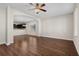 Spacious living room with ceiling fan, arched doorway, and hardwood floors at 159 Terracina Circle, Myrtle Beach, SC 29588