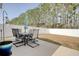 Spacious backyard with a dining set, featuring a well-maintained lawn, privacy fence and mature trees at 161 Copper Leaf Dr., Myrtle Beach, SC 29588