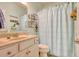 Charming bathroom with a vanity, mirror, and blue shower curtain, decorated with beach-themed accessories at 161 Copper Leaf Dr., Myrtle Beach, SC 29588