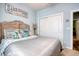 Beach themed bedroom featuring a wooden headboard, coastal decor, and muted gray and blue tones at 161 Copper Leaf Dr., Myrtle Beach, SC 29588