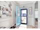 Bright foyer featuring a blue front door, stylish decor, and wood flooring at 161 Copper Leaf Dr., Myrtle Beach, SC 29588