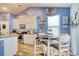 Bright kitchen with stainless steel appliances, white cabinets, and a cozy dining area at 161 Copper Leaf Dr., Myrtle Beach, SC 29588