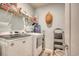 Bright laundry room with modern washer and dryer, shelving, and storage solutions for efficient organization at 161 Copper Leaf Dr., Myrtle Beach, SC 29588