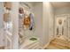 Functional mudroom with storage bench, coat rack, and beach-themed decor, leading into other rooms at 161 Copper Leaf Dr., Myrtle Beach, SC 29588