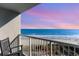 Relaxing ocean view from a private balcony at sunset with rocking chairs at 161 Seawatch Dr. # 808, Myrtle Beach, SC 29572
