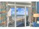 Balcony view with rocking chairs and ocean views seen through sliding glass doors at 161 Seawatch Dr. # 808, Myrtle Beach, SC 29572