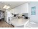 Bright kitchen features white cabinetry, a neutral countertop, and essential appliances for convenient meal preparation at 161 Seawatch Dr. # 808, Myrtle Beach, SC 29572