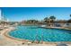 A serene outdoor pool surrounded by lounge chairs, palm trees, and a glimpse of the ocean in the background at 161 Seawatch Dr. # 808, Myrtle Beach, SC 29572