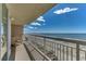 Balcony featuring chairs, table, railings, and a beautiful ocean view at 1625 S Ocean Blvd. # 802, North Myrtle Beach, SC 29582