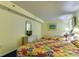 Cozy bedroom featuring two beds with bright floral comforters and beach-themed decor at 1625 S Ocean Blvd. # 802, North Myrtle Beach, SC 29582