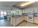 Conveniently connected kitchen area, featuring an undermount sink, white appliances, and granite counters at 1625 S Ocean Blvd. # 802, North Myrtle Beach, SC 29582