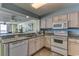 Open kitchen area, featuring an undermount sink, white appliances, and granite counters at 1625 S Ocean Blvd. # 802, North Myrtle Beach, SC 29582