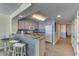 Efficient condo kitchen featuring bar seating, white appliances, and granite counters at 1625 S Ocean Blvd. # 802, North Myrtle Beach, SC 29582
