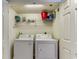 Convenient laundry area with washer, dryer, and overhead shelving for organized storage solutions at 1625 S Ocean Blvd. # 802, North Myrtle Beach, SC 29582