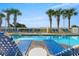 Relaxing poolside with lounge chairs and lush palm trees at 1625 S Ocean Blvd. # 802, North Myrtle Beach, SC 29582