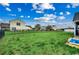 A large grassy backyard enclosed by a black metal fence and a peek of a blue kiddie pool at 177 Tibton Circle, Myrtle Beach, SC 29588