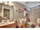 Well-lit bathroom offering vanity with sink, toilet, and shower featuring neutral tones and fixtures at 177 Tibton Circle, Myrtle Beach, SC 29588
