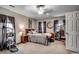 Comfortable bedroom with a large window, ceiling fan, and unique decor at 177 Tibton Circle, Myrtle Beach, SC 29588