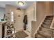 Inviting entryway featuring a decorative bench, coat closet, and staircase leading to the upper level at 177 Tibton Circle, Myrtle Beach, SC 29588