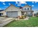 Inviting two-story home with a manicured lawn, a two-car garage, and an American flag at 177 Tibton Circle, Myrtle Beach, SC 29588
