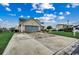 Two-story home featuring a two-car garage, American flag, and a long driveway at 177 Tibton Circle, Myrtle Beach, SC 29588
