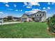 Expansive front lawn leading to a two-story home with a spacious two-car garage at 177 Tibton Circle, Myrtle Beach, SC 29588
