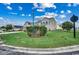 A view of a two-story home featuring a manicured lawn and a charming decorative flag at 177 Tibton Circle, Myrtle Beach, SC 29588