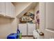 Functional laundry room featuring a washer, dryer, storage shelves, and tiled flooring at 177 Tibton Circle, Myrtle Beach, SC 29588