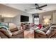 Comfortable living room with plush leather seating, ceiling fan, and entertainment center at 177 Tibton Circle, Myrtle Beach, SC 29588