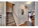 Carpeted stairs with wooden handrail lead to the upper level, adjacent to the living area at 177 Tibton Circle, Myrtle Beach, SC 29588