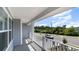 Inviting covered porch with white railings, offering a relaxing outdoor space and neighborhood views at 1848 Hardwood Ct., Conway, SC 29526