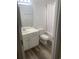 Bathroom with white vanity, mirror, toilet, and shower/tub combo with curtain at 197 Charter Dr. # D-8, Longs, SC 29568