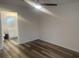 Bedroom with wood floors leading into a bathroom with modern lighting and fixtures at 197 Charter Dr. # D-8, Longs, SC 29568