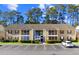 Inviting condo exterior with ample parking, landscaping, and screened-in porch at 197 Charter Dr. # D-8, Longs, SC 29568