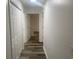 Bright hallway featuring wood-look flooring and multiple closets for storage at 197 Charter Dr. # D-8, Longs, SC 29568