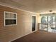 Hallway with beige siding, black door, view of nature, and railings at 197 Charter Dr. # D-8, Longs, SC 29568