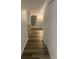 Hallway view leading into the kitchen with stainless steel appliances and modern wood floors at 197 Charter Dr. # D-8, Longs, SC 29568