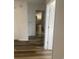 Bright hallway featuring hardwood floors leading to a modern kitchen with stainless appliances at 197 Charter Dr. # D-8, Longs, SC 29568