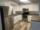 This kitchen features stainless steel appliances, generous countertop space, and white cabinetry at 197 Charter Dr. # D-8, Longs, SC 29568